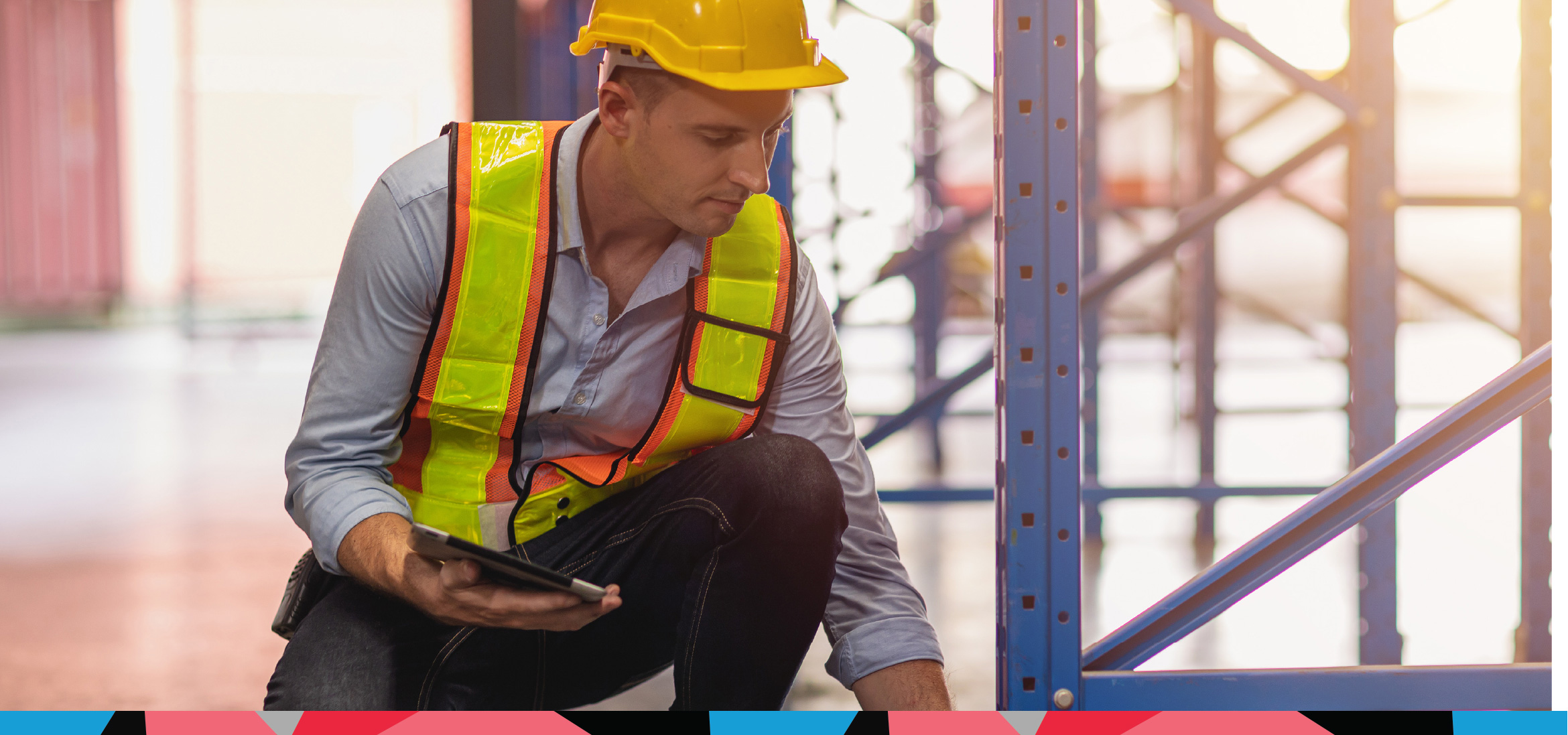 Rack inspector examining the upright post of a pallet racking bay to check for damage, overload, or compliance issues in warehouse operations.